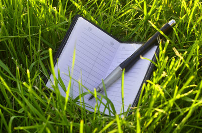 High angle view of open book on field