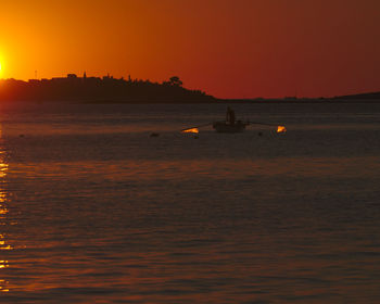 Scenic view of calm sea at sunset