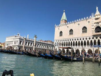 View of boats in canal against buildings