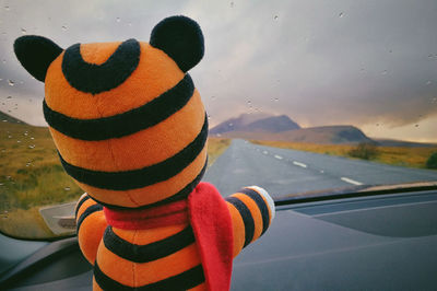 Close-up of toy car seen through glass window