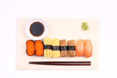 Directly above shot of sushi served on white background