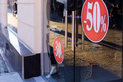 Close-up of road sign on glass window