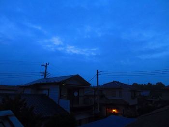 Low angle view of houses against blue sky