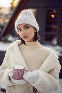 Portrait of young woman wearing warm clothing