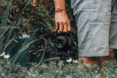 Low section of man holding plants