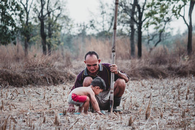 Portrait of father and son on land