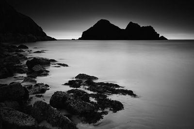 Scenic view of sea against clear sky at dusk