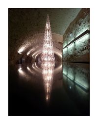 Reflection of illuminated building in water