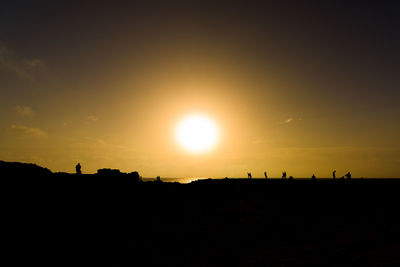 Silhouette of people at sunset