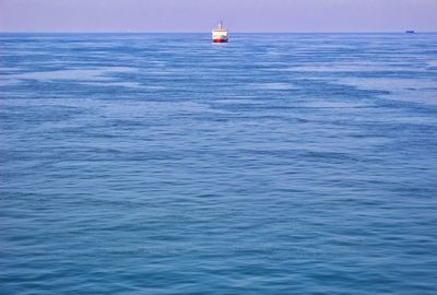 Sailboat in sea against sky