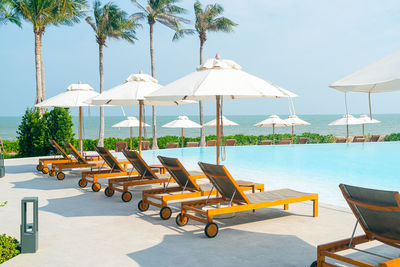 Empty chairs and tables at beach