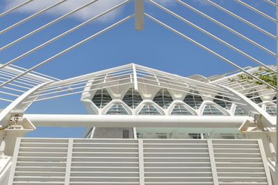 Low angle view of bridge and buildings against sky