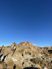 Scenic view of rocky mountains against clear blue sky