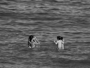 High angle view of women with kids in sea