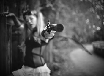 Woman shooting with handgun outdoors