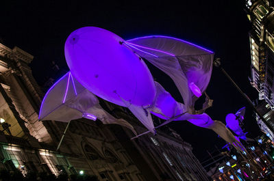 Low angle view of illuminated lights at night