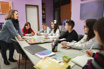 Female friends using laptop on table