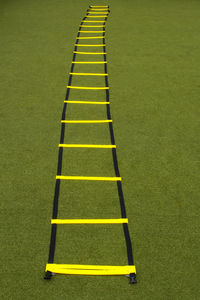 Yellow agility ladder on grass