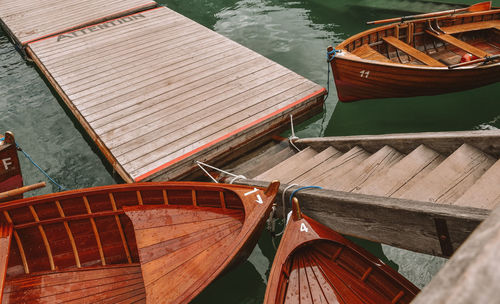 Boats moored at pier on lake