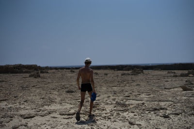 Man standing on barren landscape