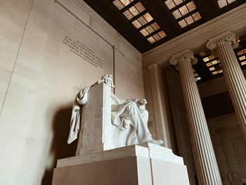 Low angle view of statue against building