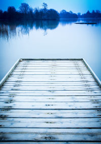 Pier on lake against sky