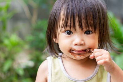 Cute baby girl eating ice cream