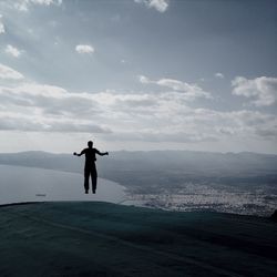 Silhouette of woman against sky