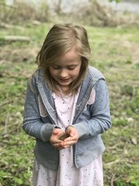 A childs happiness when holding a frog