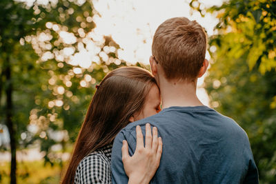 Rear view of couple kissing outdoors