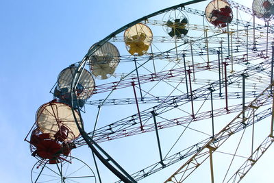 Low angle view of ferris wheel against clear sky