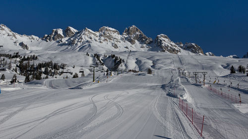 Scenic view of snow covered mountains against clear sky