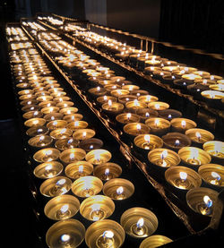 High angle view of illuminated candles arranged on table