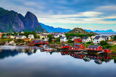 Scenic view of lake by mountains against sky