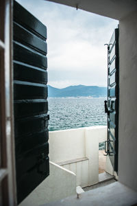 View of sea and sky seen through window