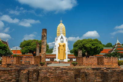 Low angle view of temple amidst buildings against sky