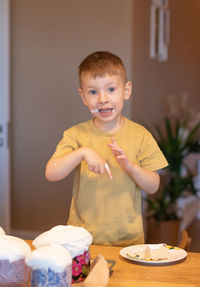 Portrait of smiling boy eating cake