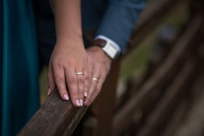 Close-up of man hand on wood