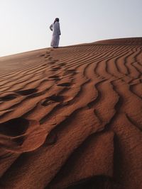 View of sand dunes against sky