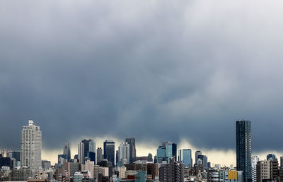 City skyline against cloudy sky