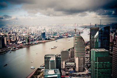 High angle view of river amidst buildings in city