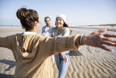 Women standing on beach
