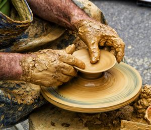 Close-up of man working in mud