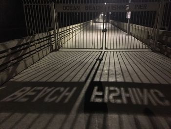 Shadow of railing on footpath