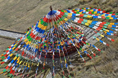 High angle view of multi colored flags on field