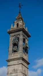 Low angle view of clock tower against blue sky