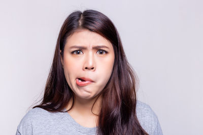 Portrait of a beautiful young woman over white background