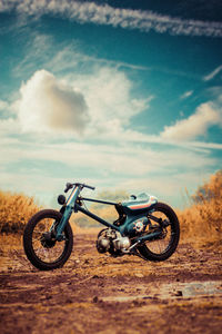 Side view of bicycle parked against dramatic sky