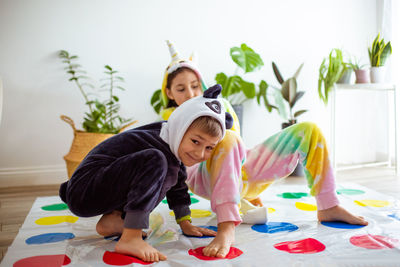 Siblings playing at home