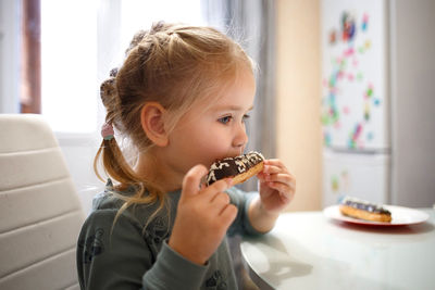Cute girl eating food at home